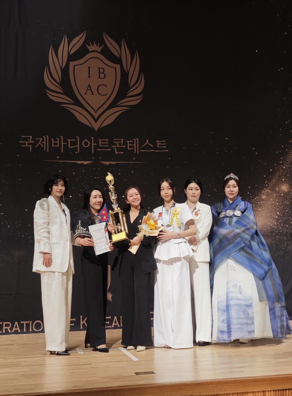 Aruna Gurung receiving the World SPMU Microblading Champion trophy at the 20th International Body Art Contest, Busan South Korea 2025